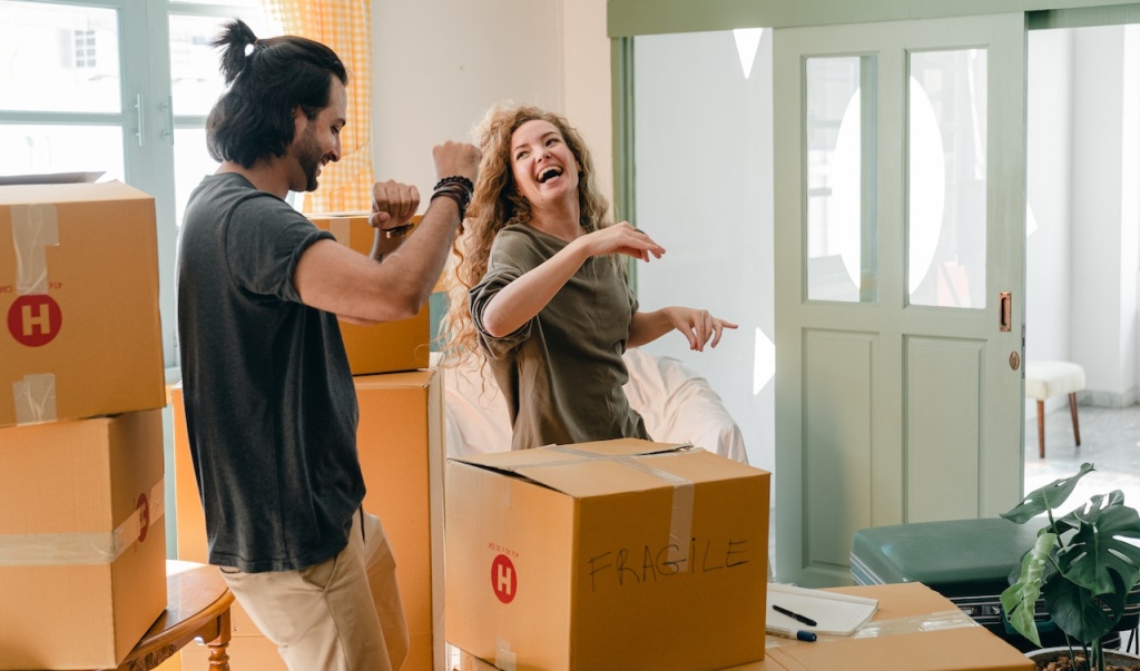 Couple dancing in a living room.