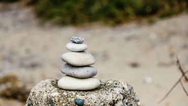 Stones of different sizes stacked up on a rock