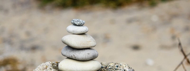 Stones of different sizes stacked up on a rock