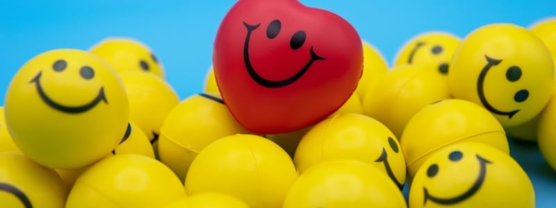 Yellow smiley face balls and a red smiley face ball