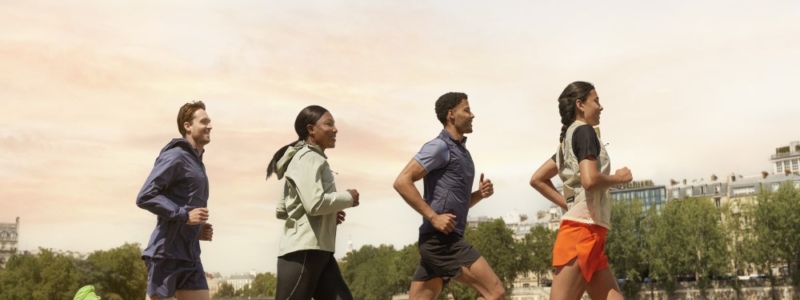 Four people running outdoors.