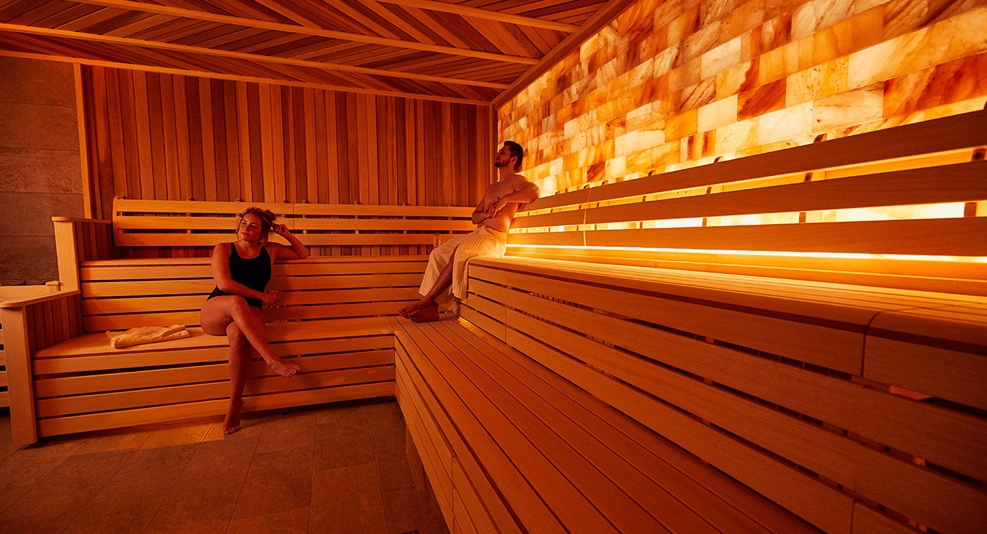 Image of a woman and a man sat in the salt spa at David Lloyd Royal Berkshire