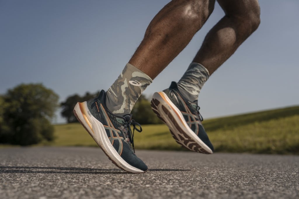 Close up of a runner's feet wearing ASICS trainers.