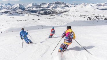 Skiers following a run down a mountain