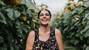 Woman smiling in a field of flowers