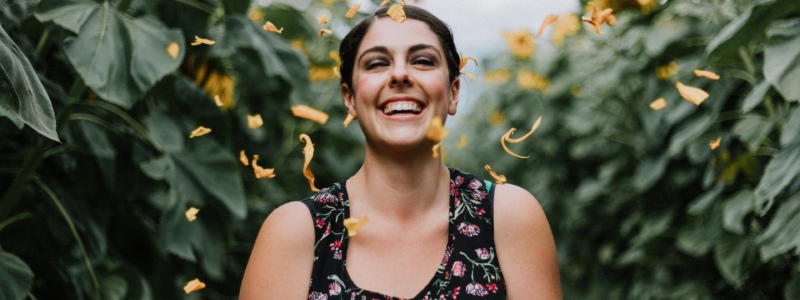 Woman smiling in a field of flowers