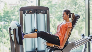 Lady on leg press in gym