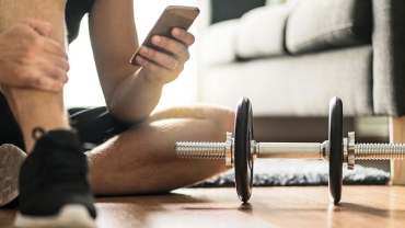 man-on-phone-exercising-at-home