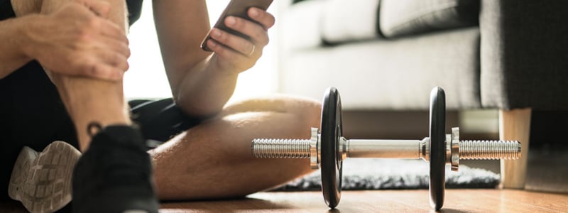 man-on-phone-exercising-at-home