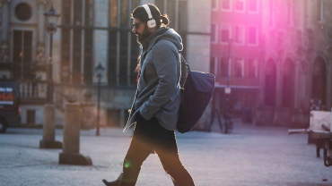 man-walking-listening-to-music