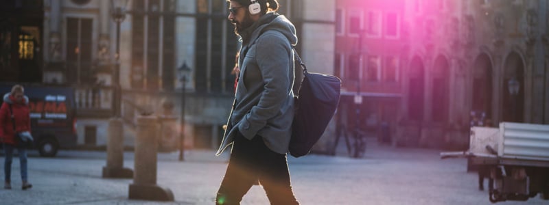 man-walking-listening-to-music