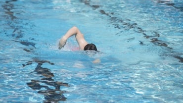 Image of a person swimming in an outdoor pool at David Lloyd.