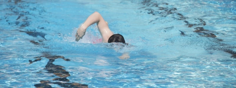 Image of a person swimming in an outdoor pool at David Lloyd.