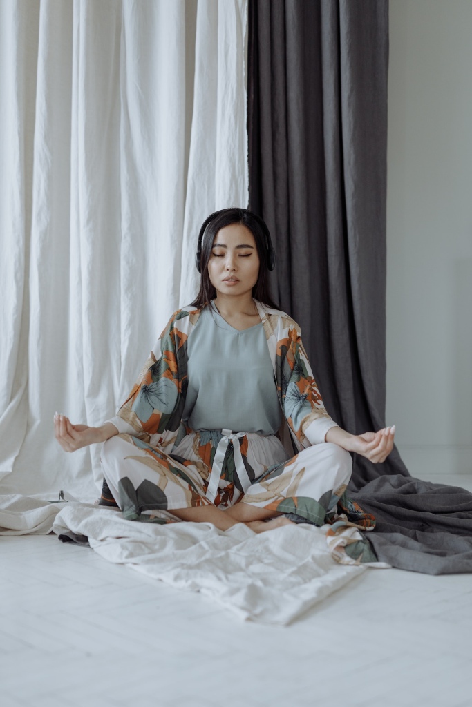 Woman meditating with headphones on