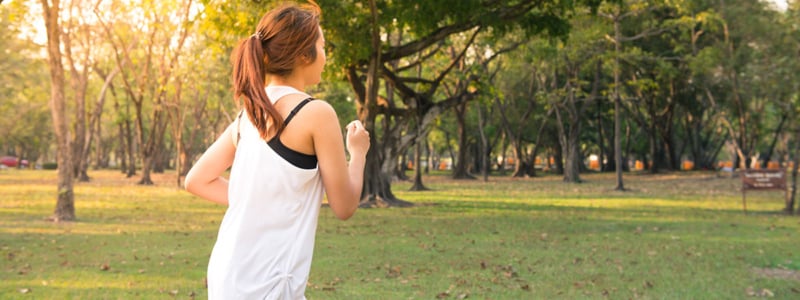 Woman running in a wooded area