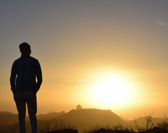 Backlist silhouette of a man outdoors.