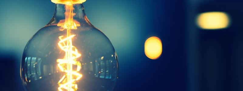 A close-up of a lit light bulb.